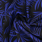 Viscose printed tropical leaves in royal blue with black background