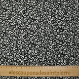 Viscose printed with myriad gray and white flowers on a black background
