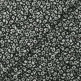 Viscose printed with myriad gray and white flowers on a black background