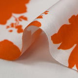 Viscose imprimée silhouettes de fleurs orange fond blanc
