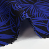 Viscose printed tropical leaves in royal blue with black background