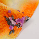 Viscose imprimée fleurs violettes fond jaune et orange