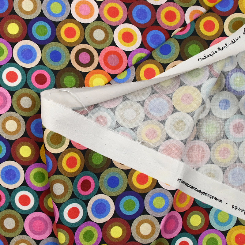 Coton imprimé cercles des sixties multicolore fond noir