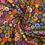 Coton imprimé cercles des sixties multicolore fond noir