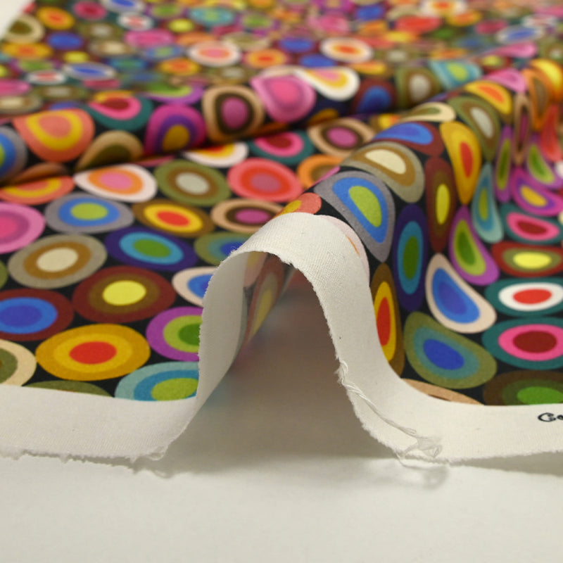 Coton imprimé cercles des sixties multicolore fond noir