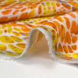 Lin viscose imprimé écailles ensoleillées orange et jaune fond écru