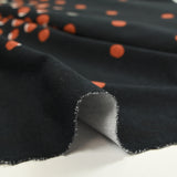 Jersey de coton imprimé évasion de pois noir, rouille et sable
