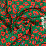 Viscose imprimée fleurs rouges fond vert à pois noir