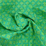 Coton matelassé double face ethnique et fleurs vert anis au mètre