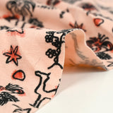 Jersey de coton imprimé désert fond rose