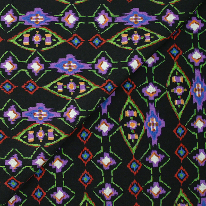 Crêpe viscose imprimé éclat mystique violet et vert fond noir