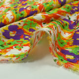 Crépon de viscose imprimé pensée floue violet et vert fond orange