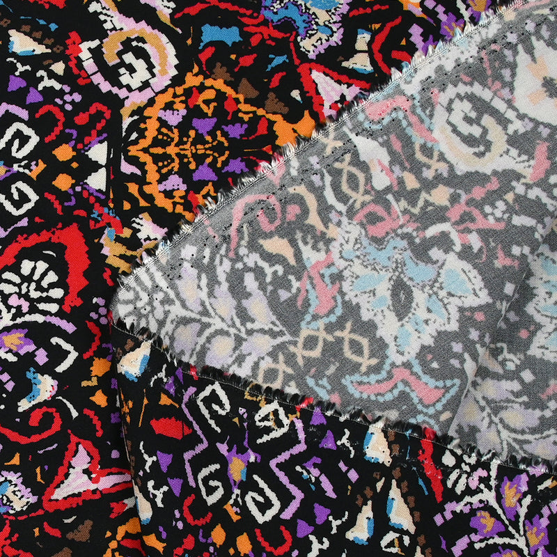Viscose imprimée frénésie orange, rouge et violet fond noir