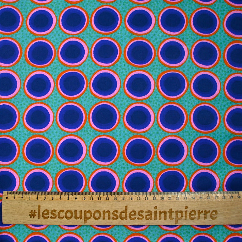 Coton imprimé rond rose, orange et bleu fond vert