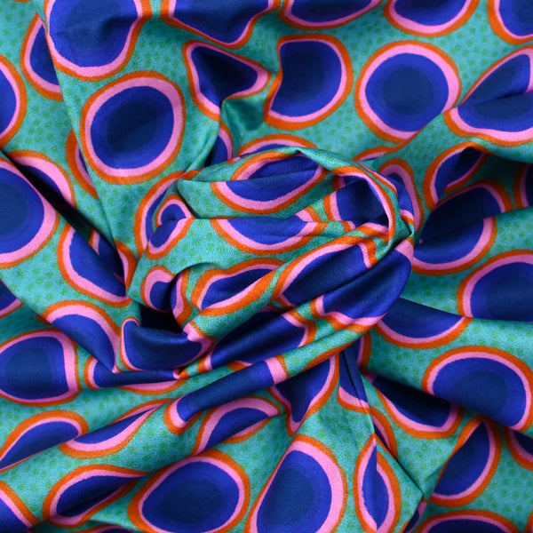 Coton imprimé rond rose, orange et bleu fond vert