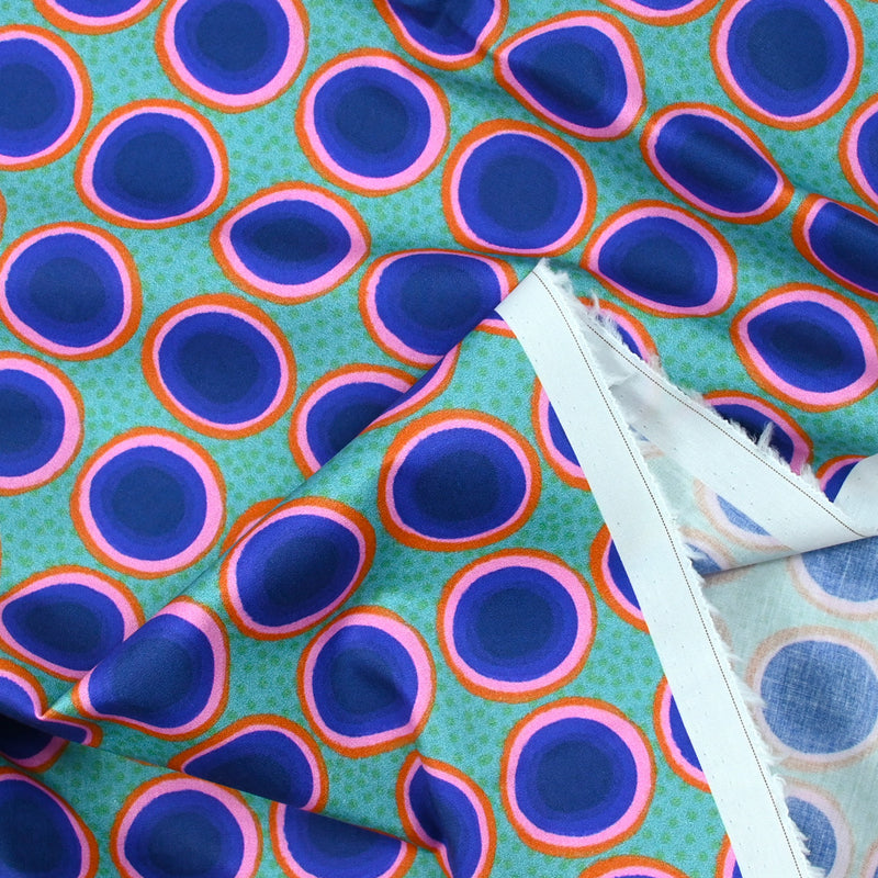 Coton imprimé rond rose, orange et bleu fond vert