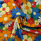 Coton imprimé floraison disco bleu roi, orange et jaune pâle