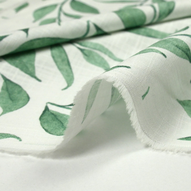 Coton tissé aspect lin imprimé feuilles volantes fond blanc