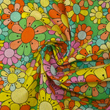 Coton imprimé flower power rose fond vert