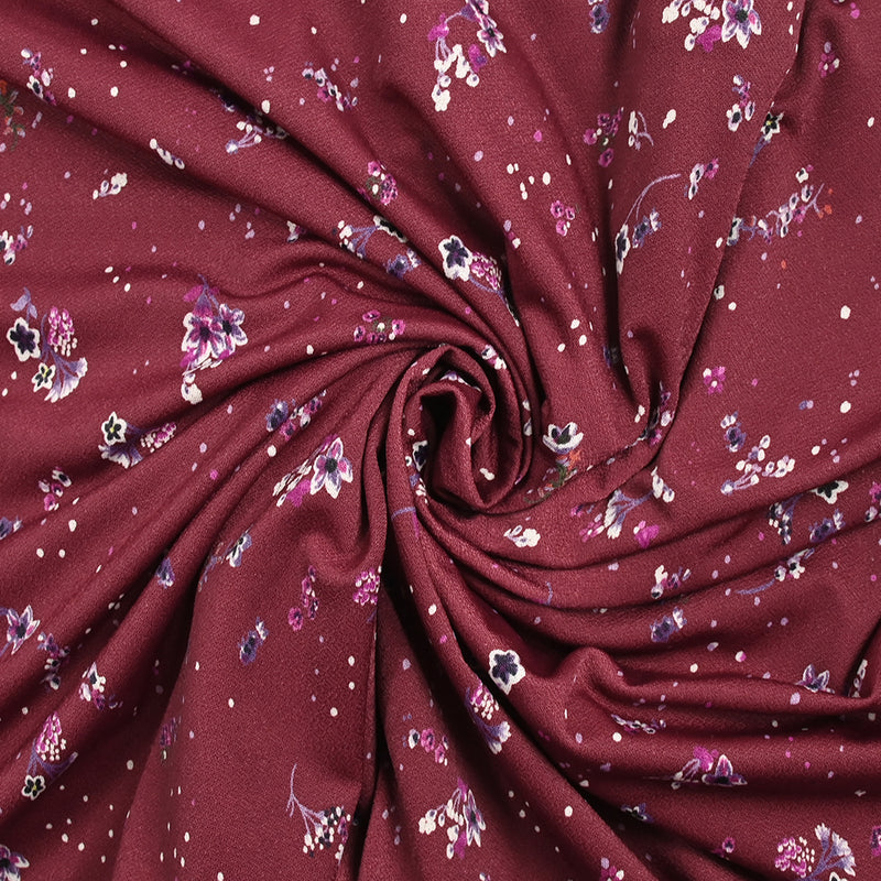 Maille crêpe imprimée petites fleurs fond lie de vin