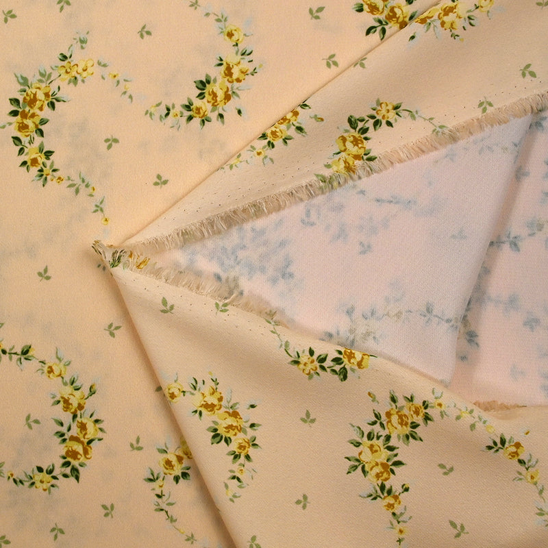 Crêpe imprimé serpent de fleurs fond pêche