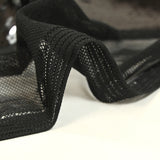 Sequins noirs sur tulle stretch