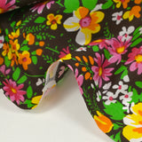 Coton imprimé vent floral orange et fuchsia fond marron