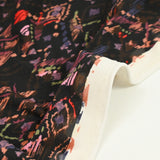 Maille crêpe imprimée ethnique fond noir