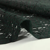 Maille dentelle ajourée impression reptile fond vert foncé