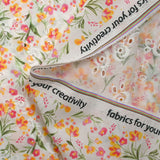Broderie anglaise imprimée petites fleurs rose et jaune fond blanc