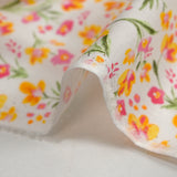 Broderie anglaise imprimée petites fleurs rose et jaune fond blanc