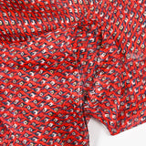 Mousseline imprimée bande satin oeil bleu fond rouge