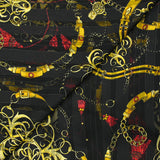 Printed muslin, satin band, chains and tassels, black background