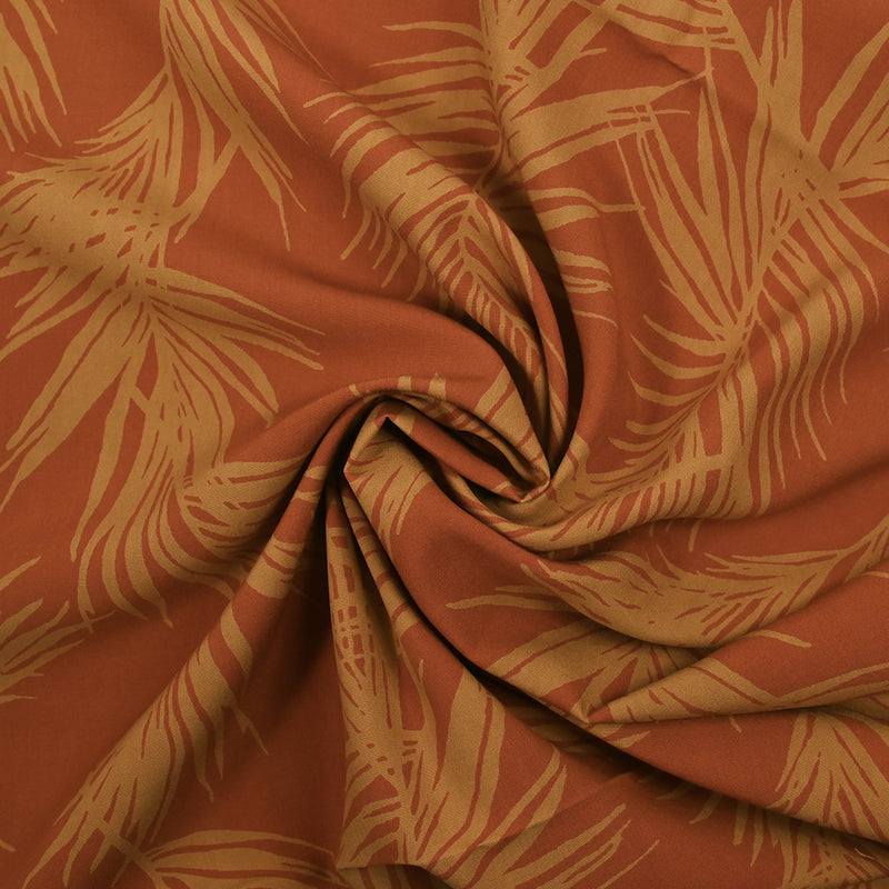 Viscose imprimée feuilles de palmier fond orange brûlé