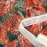 Green and orange pointillism satin band printed muslin