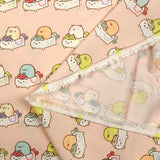 Viscose imprimée Sumikko Gurashi fond pêche