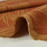 Viscose imprimée feuilles de palmier fond orange brûlé