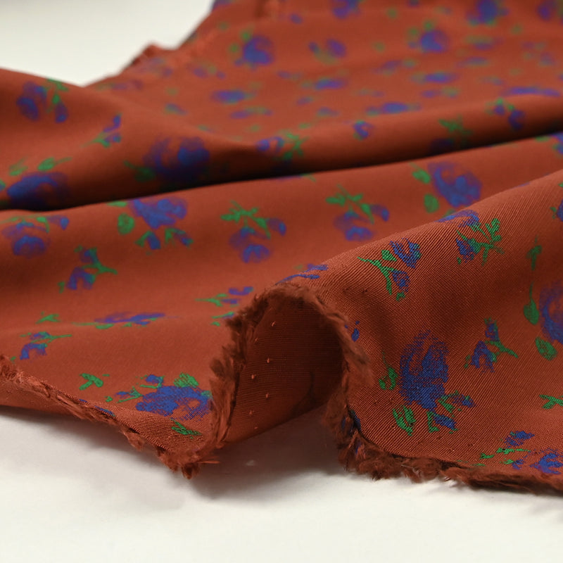Polyviscose imprimée fleurs bleues fond brique