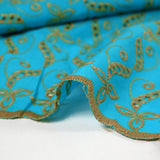 Broderie anglaise festonnée beige Éléonore fond bleu azur