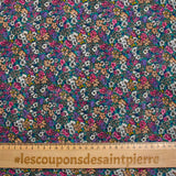 Mousseline de polyester lancée découpée fleurs fond turquoise