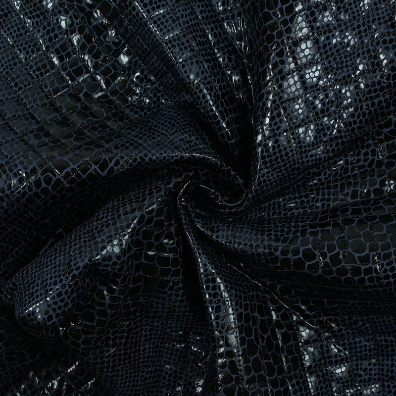 Matelassé imprimé reptile fond bleu marine
