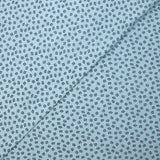 Punto de algodón estampado hojas fondo azul cielo