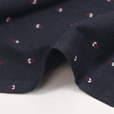 Punto de algodón con estampado de espigas de trigo burdeos, fondo azul marino