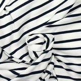 Fine cotton jersey with navy striped print and white background
