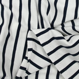 Fine cotton jersey with navy striped print and white background