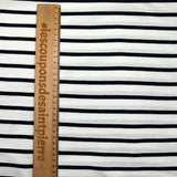 Fine cotton jersey with navy striped print and white background