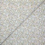 Voile de coton imprimé digital fleurettes bleues et feuillage vert sur fond écru