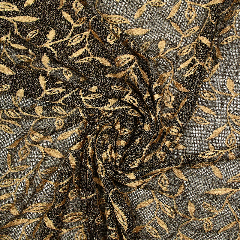 Maille dentelle ajourée motif végétal doré fond noir