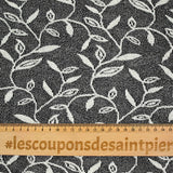 Maille dentelle ajourée motif végétal blanc fond noir