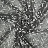 Maille dentelle ajourée motif végétal blanc fond noir